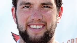 Andrew Luck walks by a wedding photo, joins it