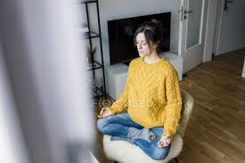 When you can't comfortably reach the ground while sitting up straight and all the way back, it puts pressure on your low back so a lot of us end up pulling our legs up into the chair. Mature Woman Sitting Cross Legged On Chair With Eyes Closed Meditating At Home Person Relaxation Stock Photo 281267788