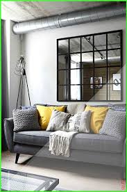 A Gray Industrial Living Room With A Gray Sofa And Yellow Pillows As A Pop Color Color Gray Industri In 2020 Living Room Grey Yellow Living Room Black Living Room