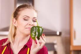 Funny woman taking bite of bell pepper — Stock Photo © Anetlanda #273674830