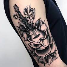 Guitar Tattoo With Flowers By Norberto Gonzalez Guitar Tattoo Design Music Tattoo Designs Tattoos For Guys