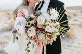 Bride with bouquet at modern and minimal wedding in san diego, california. Palm Fronds Promises Tropical Desert Vow Renewal In Palm Springs Wedding Flower Inspiration Bouquet Beach Wedding Decorations Pink