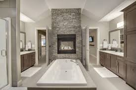 Ensuite With Double Sided Fireplace Master Bedroom With Double Sided Fireplace Stone Surro Double Sided Fireplace Master Bedroom Bathroom Farmhouse Fireplace