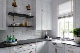 The timeless combination of black, gray, and white is shown in this kitchen scene, which features a black forest granite countertop and white carrara subway tile in the backsplash. White And Black Butlers Pantry With Leathered Black Granite Countertops Transitional Bathroom