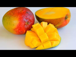 Leaving a small space on the left and right sides of the stem, use a chef's knife to cut off the sides of the mango. How To Cut And Dice A Mango Youtube