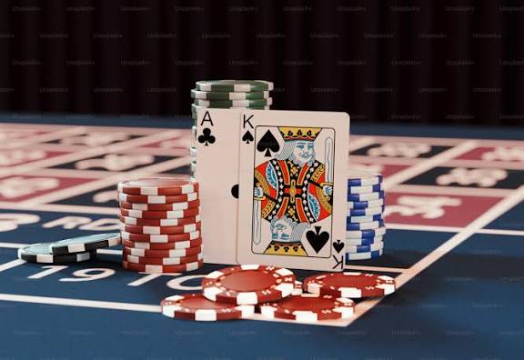 A casino table with poker chips and playing cards - Photo on Unsplash+