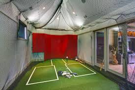 Need to get in a little batting practice? Built For Both Golf And Baseball This Batting Cage Was Designed And Installed By Practice Sports Indoor Batting Cage Batting Cage Backyard Batting Cages
