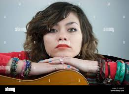 Hattie Marsh beautiful young musician modeling over a guitar Stock Photo