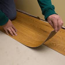 Strip Of Vinyl Plank Flooring Being Stuck In Place On The Subfloor Vinyl Plank Flooring Luxury Vinyl Plank Flooring Installing Vinyl Plank Flooring