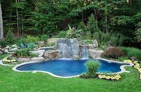 We feature an extensive collection of styles and sizes of pool rock waterfall formations with or without the uniquely designed edge rocks that compliment any pool's size requirements and. Landscape Around The Pool And The Waterfall Define The Aura Of This Gorgeous Pool Plant Pool Landscape Design Swimming Pool Landscaping Swimming Pools Backyard