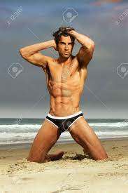Check out the top men's swim trunks and swimsuits for style and comfort. Sexy Male Model In Fashion Swimwear Posing On The Beach Stock Photo Picture And Royalty Free Image Image 13994715