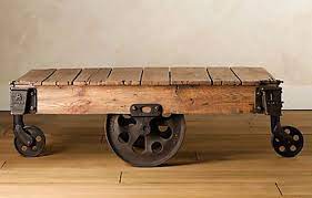 The first thing you notice about this coffee table is the dark oak top, rich with grain swirls, scratches, color variation, and stain patterns, which give it the cozy feel of a patchwork quilt. Reclaimed Factory Cart Table From Restoration Hardware