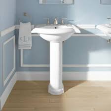 White Pedestal Sink In A Light Blue Bathroom With White Moulding And Mirror Hanging On The Wall Kohler Bathroom Sink Light Blue Bathroom Sink