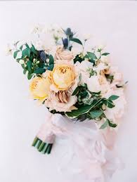 Modern, minimal bouquet with yellow daffodils, roses and banana leaves. 20 Yellow Wedding Bouquets To Brighten Up Your Big Day Martha Stewart