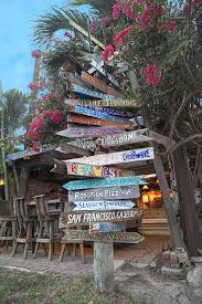 Panoranic waterfront views and outdoor dining, fresh local seafood. Hogfish Bar And Grill Directional Sign Photograph By Betsy Knapp