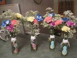 Baby Bottle Centerpieces For Baby Shower So Cuter Little Pacifiers Tied With A Pink Ribbon On Baby Shower Princess Baby Shower Fun Paris Baby Shower Theme