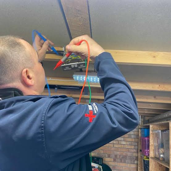 Electrician connecting a USB wall faceplate in a Kidbrooke living room