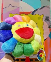 Murakami's flower plushes are known for being colorful, so to start off our top 5 we're going with something a bit different. Takashi Murakami Rainbow Flower Cushion Murakami Flower Plush Moma Exclusive Moma Exclusive This Murakami Murakami Flower Rainbow Flowers Flower Wallpaper