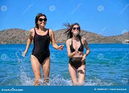 Mother and Teen Daughter Together on Beach, Running by Sea in Swimsuit  Stock Image - Image of parent, people: 182085187