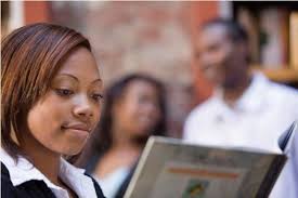 African American female student reading a book.