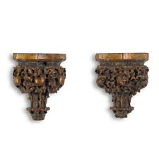 A pair of polychrome and parcel-gilt carved oak wall brackets, probably  English, 15th century