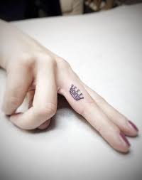 A colorful crown tattoo placed on the upper back of a lady. Cute Small Meaningful Tattoos For Women Crown Tattoo On Finger Crown Tattoos For Women Small Finger Tattoos Crown Finger Tattoo