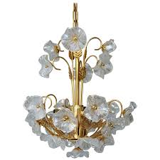The chandeliers made from murano glass in the style of the early twentieth century are distinguished by the elegance of the profiles along with the clean and essential lines. Iridescent Italian Murano Glass And Brass Flower Chandelier For Sale At 1stdibs