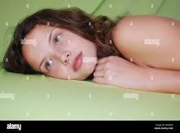 portrait of a young female teen of 14, as she lies