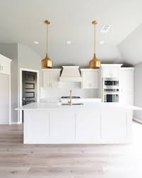 Black And White Quartz Kitchen Modern White Kitchen With Modern Gold Pendant Lights White Quartz Countertops White Glass Backsplash White Modern Kitchen Black Interior Doors Doors Interior