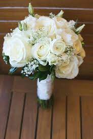 Zesty lemon and white everlasting bridal bouquet with gorgeous ferns. Lovely Hand Tied Wedding Bouquet Comprised Of White Roses White Ranunculus White Lisianthus B Flower Bouquet Wedding White Wedding Flowers Wedding Flowers