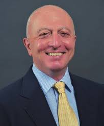 WMU's President, Dr. Edward Montgomery, driving the Bronco Baja vehicle in  front of The College of Engineering and Applied Sc