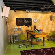 Neutral basement features a sectional and wood accents. Basement Wall Ideas Basement Makeover Painted Concrete Floors Basement On A Budget