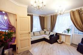 A welcoming and relaxing monochromatic room with light lilac walls, lilac and dusty pink bedding, a lilac clock and various accessories. Small Apartment Ideas And Purple Accents Creating Spacious And Modern Interior Design