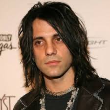 A chain is tied around criss's neck and two guys pull from either end of the chain. Criss Angel Agent Speaker Fee Booking Contact