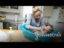Using the washcloth, wash your baby's face with clear water. How To Wash Baby S Face Neck Johnson S Youtube