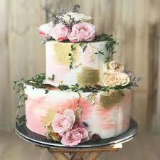 The floral 90 cake topper that matches the floral cake layer is a wonderful touch! Pastel Pink And Gold Swirl Floral Cake With Thyme
