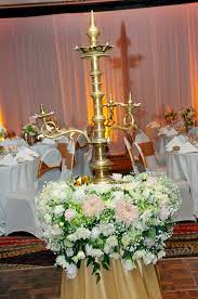 The Traditional Oil Lamp Decorated With Flowers At Ayanthi S And Asela S Wedding At The Oak Room Traditional Wedding Decor Oil Lamp Decor Wedding Decorations