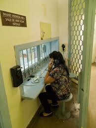 Woman At Jail Prison Visit Area A Woman Speaking Through Telephone At An Inmate Ad Visit Area Prison Woman Jail Ad Prison Jail Areas