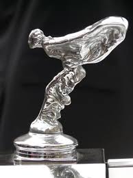 The emblem which you are referring is called spirit of ecstasy and is one of the priced possession of rr. Design Evolution Of Rolls Royce Emblem Over The Years Did You Know Cars
