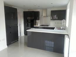 This light grey gloss kitchen has the added benefit of being available on a short 5 day lead time & is only available from independent kitchen showrooms. Charcoal Grey Gloss Kitchen Units White Worktops And Grey Tiled Floor Grey Gloss Kitchen Gloss Kitchen White Worktop