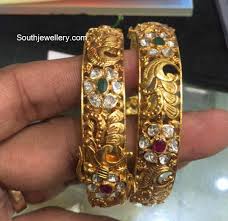 22 Carat Gold Antique Nakshi Bangles Studded With Polki Diamonds Rubies And Emeralds By Premr Gold Bangles Indian Gold Jewellery Design Necklaces Gold Bangles