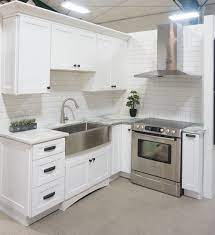 Modern farmhouse kitchen with alabaster and naval shaker cabinets. White Cabinets Shaker Door Style White Marble Countertops White Bevelled Su Shaker Style Kitchen Cabinets White Shaker Kitchen White Shaker Kitchen Cabinets