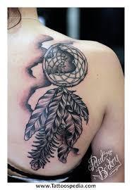 There is a gorgeous gemstone jewel in the center along with beads and a beaded hoop at the top for hanging. Dream Catcher Tattoo Design Wrist