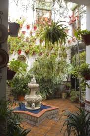 Typical Andalusian Patio With Fountain And Numerous Plants Geraniums Outdoor Patio Designs Plants Courtyard Garden