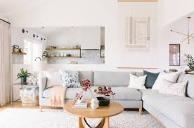 To create a strong contrast against a light beige sofa, introduce accent sofa cushions in dark shades of navy, burgundy, forest green and brown, or work with pastel hues: White Wall Wooden Floor Interior Design Ideas Light Grey Couch Printed Throw Pillows Blanket Wood Living Room Stands Grey Couch Living Room Elegant Living Room
