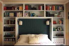 This large bed with bookshelf and many drawers in the base of the bed is a perfect combination of a comfortable place to relax and store. Bookcase Around Bed Bookshelves In Bedroom Shelves In Bedroom Bedroom Headboard
