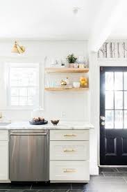 White And Gold Kitchen Features White Shaker Cabinets Adorned With Brass Pulls Paired With Calcutta Mar Contemporary Kitchen Kitchen Remodel Kitchen Renovation