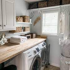 This laundry room from harrison design has lots going for it with its shiplap walls, designated basket storage, farm sink, hanging rod and counter workspace. How To Diy A Farmhouse Laundry Room