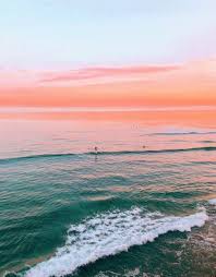 Photo by samba to the sea. Pretty Sunset On The Beach Pink Orange Sunset Over A Green Turquoise Ocean Wanderlust Ocean Vibes Nature Photography Beach