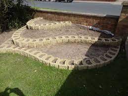 Terraforce Hollow Core Retaining Wall Blocks Being Used To Create A Low Terraced Flower Be Landscaping Blocks Retaining Wall Blocks Landscaping Retaining Walls